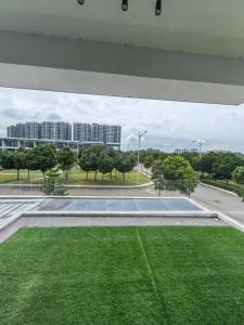 a tennis court in the middle of a field of grass at Lakeside house in Gua Sai