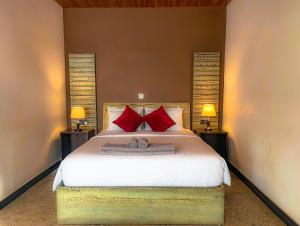 a bedroom with a large bed with red pillows at Hotel 198 Negombo in Negombo +114 photos