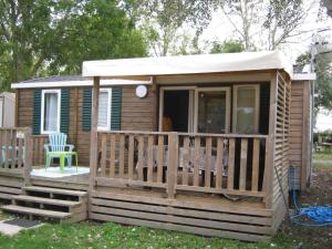 a small cabin with a porch and a chair at erick in Angles