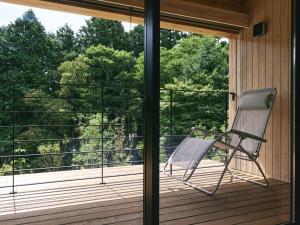a rocking chair sitting on a screened in porch at GEOSPOT Motohakone C 2026年1月 New Open in Hakone