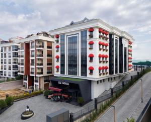 a large white building with red spheres on it at İzz Hotel Koşuyolu in Istanbul