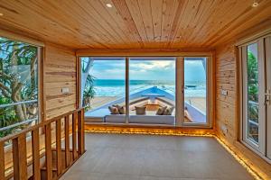 an empty room with a view of the ocean at Jungle Beach Ahungalla in Ahungalla