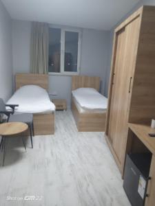 a small room with two beds and a table at Tekirdağ Begonya Hotel in Kapaklı