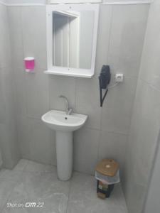 a white bathroom with a sink and a mirror at Tekirdağ Begonya Hotel in Kapaklı