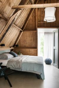 a bedroom with a large bed in a attic at It Buterhus in Balk