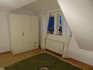 a white room with a window and a bed at Ferienwohnung Strunz Backnang ruhig zentrumsnah & S-Bahn in Backnang