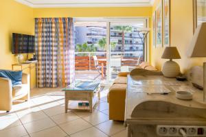 a living room with a couch and a table at ZEN MARINA in Mandelieu-La Napoule