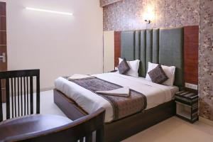 a bedroom with a bed and a chair in it at Hotel HSP Suites - Near IGI Airport, New Delhi in New Delhi +45 photos