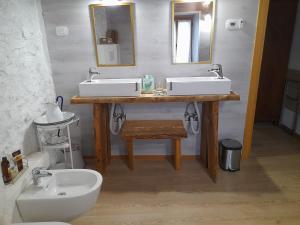 a bathroom with two sinks and a mirror and a toilet at Casa 1885 in Belluno +41 photos