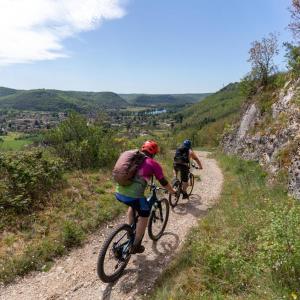 two people riding bikes down a dirt trail at Couvent de Vaylats in Vaylats