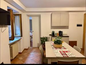 a kitchen and dining room with a table and chairs at Dolomiti Cadore Home in San Pietro di Cadore +14 photos