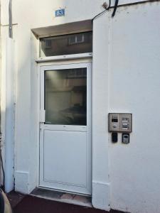 a door in a white building with at Le cocon - STUDIO- MACON in Saint-Laurent-sur-Saône