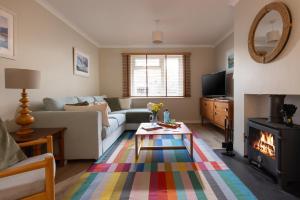 a living room with a couch and a fireplace at Easy Oars - Flushing, Falmouth in Flushing +19 photos