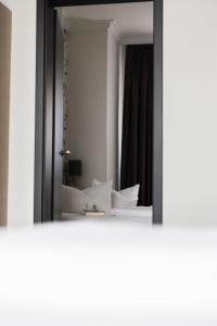 a mirror reflection of a bed in a room at N9 Hotel Nürnberg-City in Nuremberg