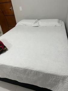 a close up of a white bed in a room at Hotel Santa Rita in Amarante do Maranhão