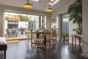 a dining room with a wooden table and chairs at Easy Oars - Flushing, Falmouth in Flushing