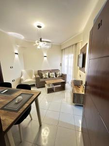 a living room with a couch and a table at Downtown Keys in Hurghada