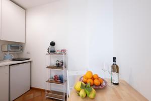 a kitchen with a table with a bowl of fruit at Casa Cinque in Positano +11 photos