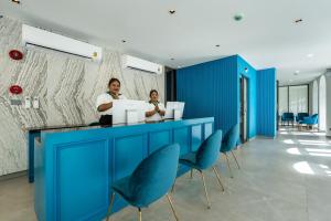 two women standing at a blue counter with blue chairs at Palmetto Park Residence in Karon Beach +92 photos