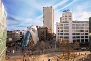 a view of a city with people walking in the street at Hotel La Reine in Eindhoven +15 photos