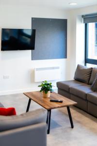 a living room with a couch and a coffee table at Stay at St Marks in Lincoln