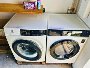two washing machines are sitting next to each other at Home Ocean 360 piscine chauffée et SPA in Saint-Leu