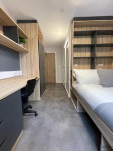 a bedroom with a bed and a desk and a bed sidx sidx sidx at Stay at St Marks in Lincoln