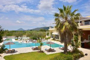 an image of a resort with a swimming pool at Ektor Villa in Agios Georgios