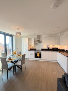 a kitchen and dining room with a table and chairs at Grace House in St. Albans