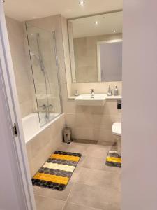 a bathroom with a shower tub and a sink at Grace House in St. Albans +5 photos