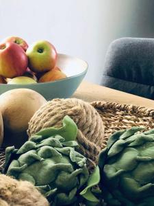 a table with a bowl of fruit and vegetables on it at Wanderlust Chiemgau in Bad Endorf