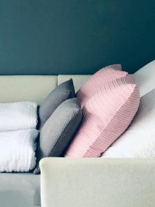a pile of pillows sitting on a couch at Wanderlust Chiemgau in Bad Endorf