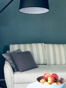 a bowl of fruit on a table next to a couch at Wanderlust Chiemgau in Bad Endorf +29 photos