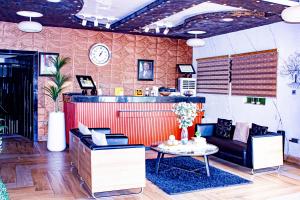 a living room with a couch and a table at Fobbs Apartment and Suites in Asaba +32 photos