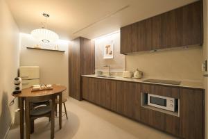 a kitchen with a table and a microwave at Stay Seongsu Villa in Seoul