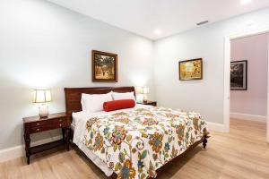 a bedroom with a bed and a nightstand and two lamps at Imola Vacation Rental - Remodeled Pool Home Minutes from Vanderbilt Beach! Family-Friendly Retreat with 4 BR 4 BA and Private Screened Pool! in Naples +32 photos
