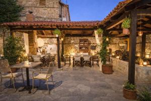 an outdoor patio with a table and chairs at Hagiati Guesthouse - Edessa Cozy Mountain Retreat in Edessa