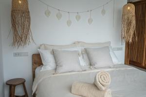 a bedroom with a white bed with a towel on it at InnSpire Villa - Breathtaking Sunset View in Hinkong +6 photos