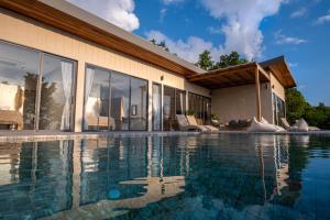 a swimming pool in front of a house at InnSpire Villa - Breathtaking Sunset View in Hinkong