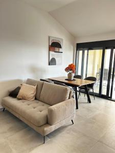 a living room with a couch and a table at Apartment Sunset - Private Pool & Sea View in Bar