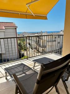 a table and a chair on a balcony at Apartment Sunset - Private Pool & Sea View in Bar