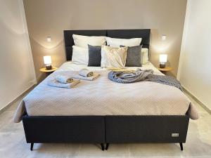 a large bed with two towels on top of it at Apartment Sunset - Private Pool & Sea View in Bar +20 photos