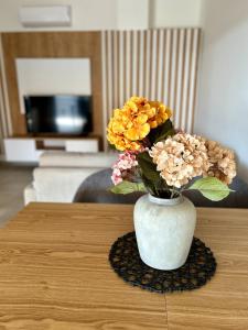 a vase filled with flowers sitting on a table at Apartment Sunset - Private Pool & Sea View in Bar