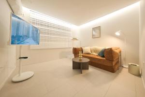 a living room with a couch and a flat screen tv at Stay Seongsu Villa in Seoul +72 photos