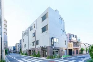 a white building on the side of a street at Seed INN Haneda Terrace 201 in Tokyo