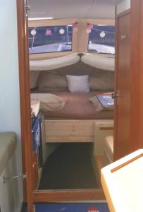 a small room with a bunk bed in a boat at Sleeping on the GilgaBoat! in Nakskov