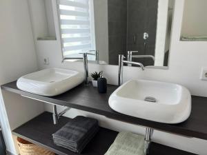 a bathroom with a sink and a mirror at Guesthouse in Neuhäusel +17 photos