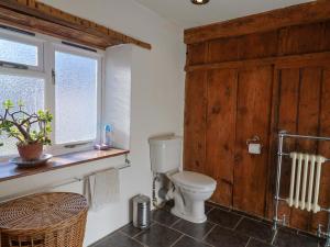 a bathroom with a toilet and a window at Rope Cottage in Bridport +29 photos