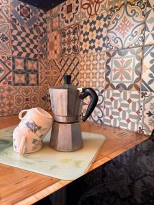 a tea kettle sitting on a table with tiles at Casa na Colina in Almancil