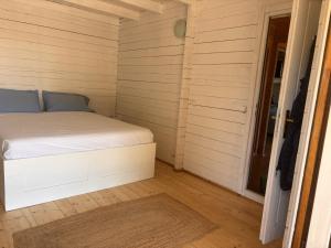 a bedroom with a bed in a room with a door at Casa na Colina in Almancil